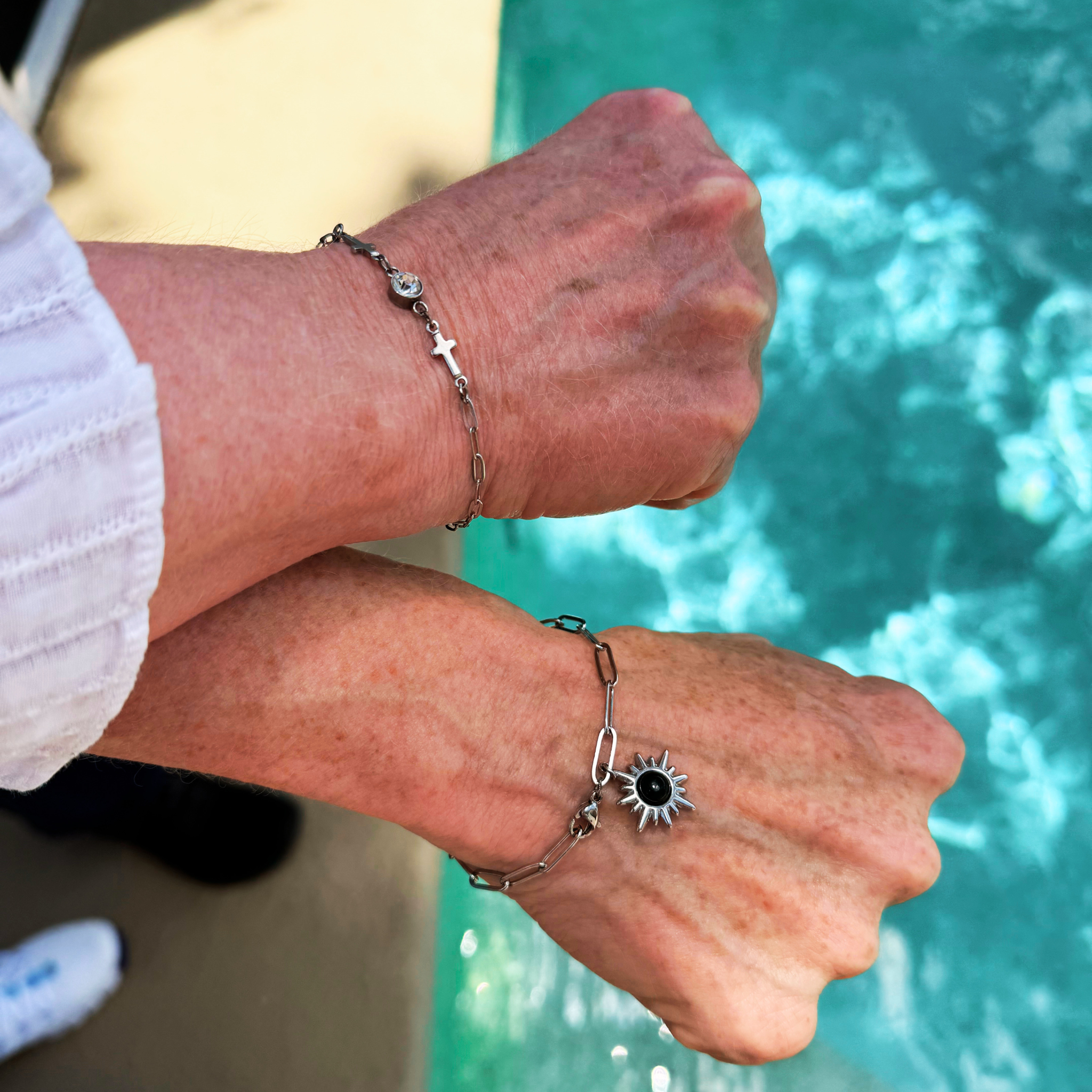 Two permanent bracelets worn beside a pool