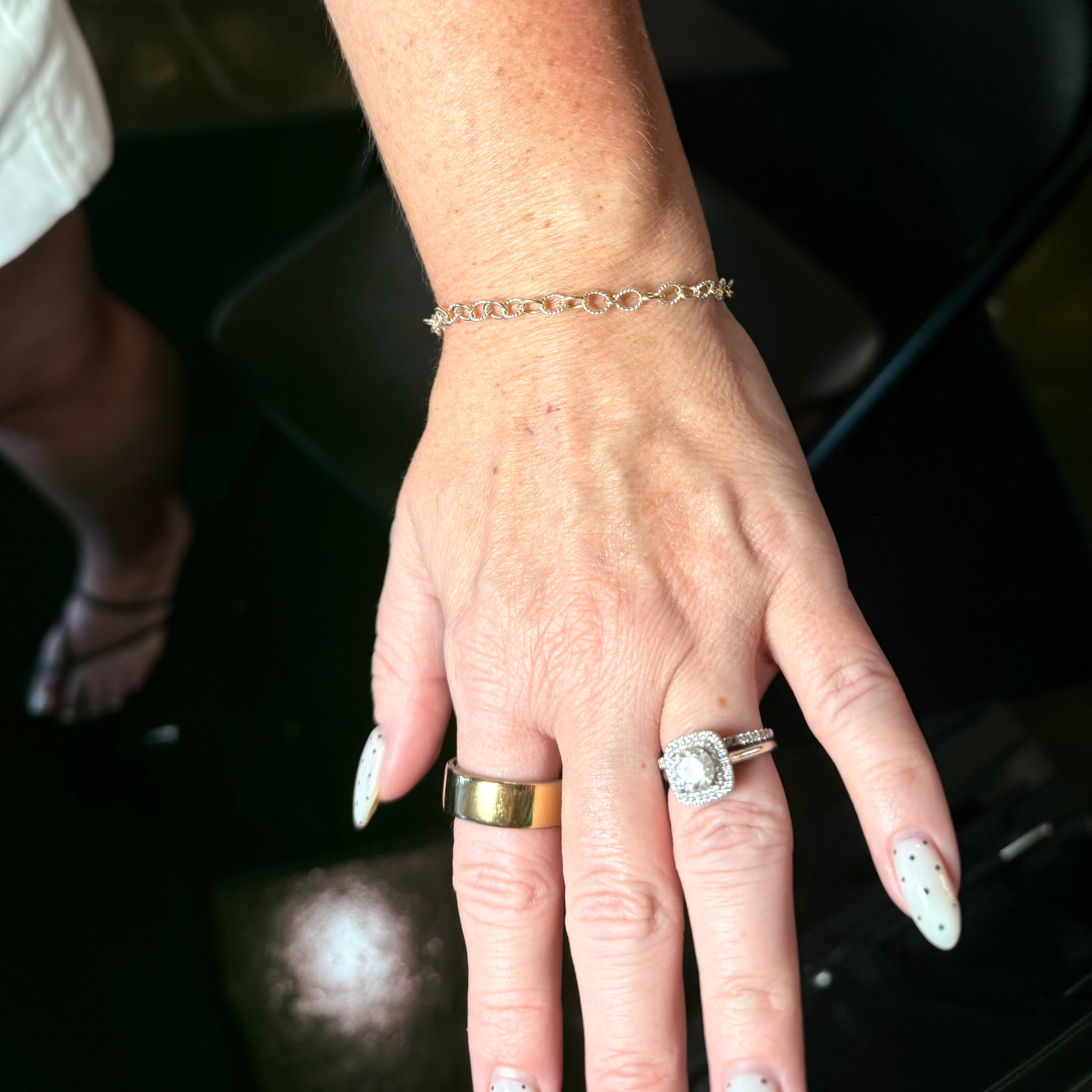 Silver permanent bracelet worn on a hand